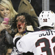 Illustration for article titled Hockey Players Face Gets Bloodied While Lady With A Pink BlackBerry Cover Sort Of Watches